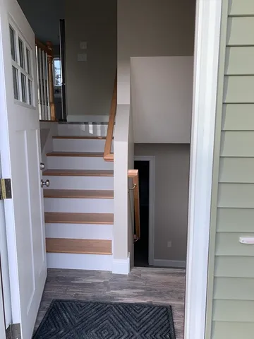 a view of entryway and hall with wooden floor