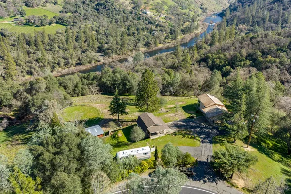 an aerial view of a house with swimming pool and outdoor seating