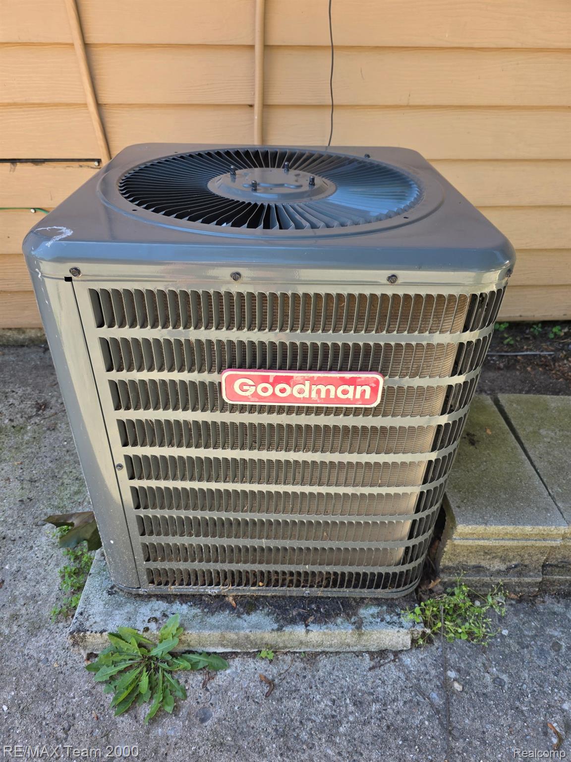 38114 Walnut Street Romulus, MI 48174 - Photo 17 of 18 Goodman HVAC exterior condenser unit on a concrete pad