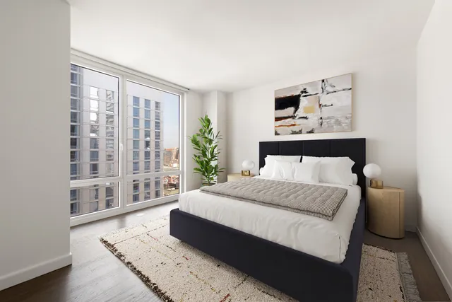 a bedroom with a large bed and a window