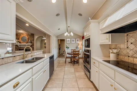 a kitchen with stainless steel appliances a sink stove and cabinets