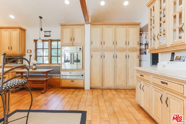 a kitchen with stainless steel appliances granite countertop a refrigerator and cabinets