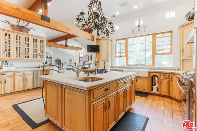 a kitchen with stainless steel appliances granite countertop a sink stove and cabinets