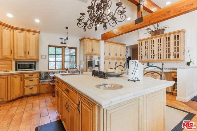 a kitchen with stainless steel appliances granite countertop a sink and cabinets
