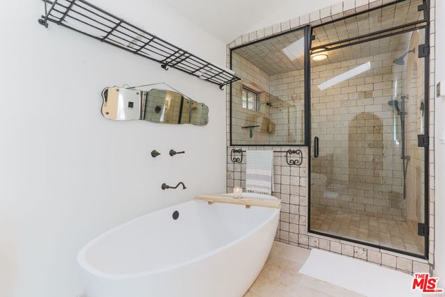 a bathroom with a bathtub and shower
