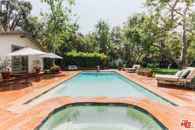 a view of swimming pool with chairs and tables