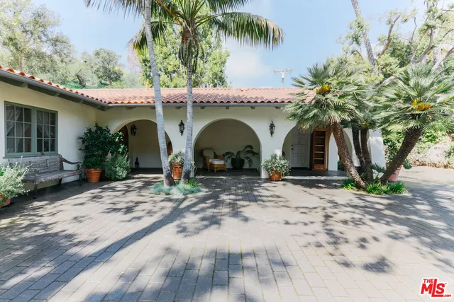a backyard of a house with barbeque oven and outdoor seating