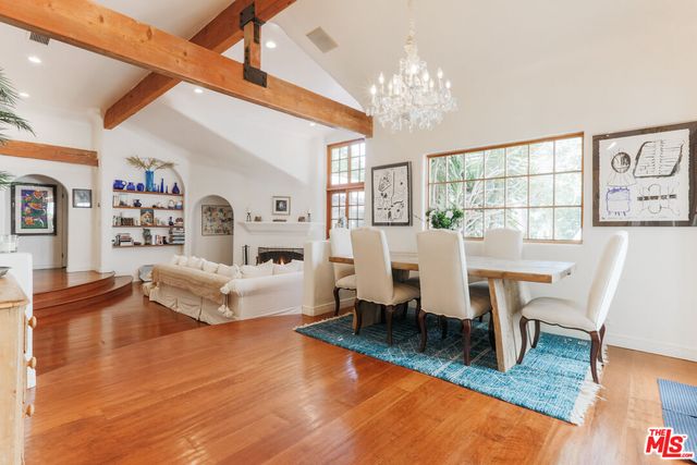 a living room with fireplace furniture and a wooden floor