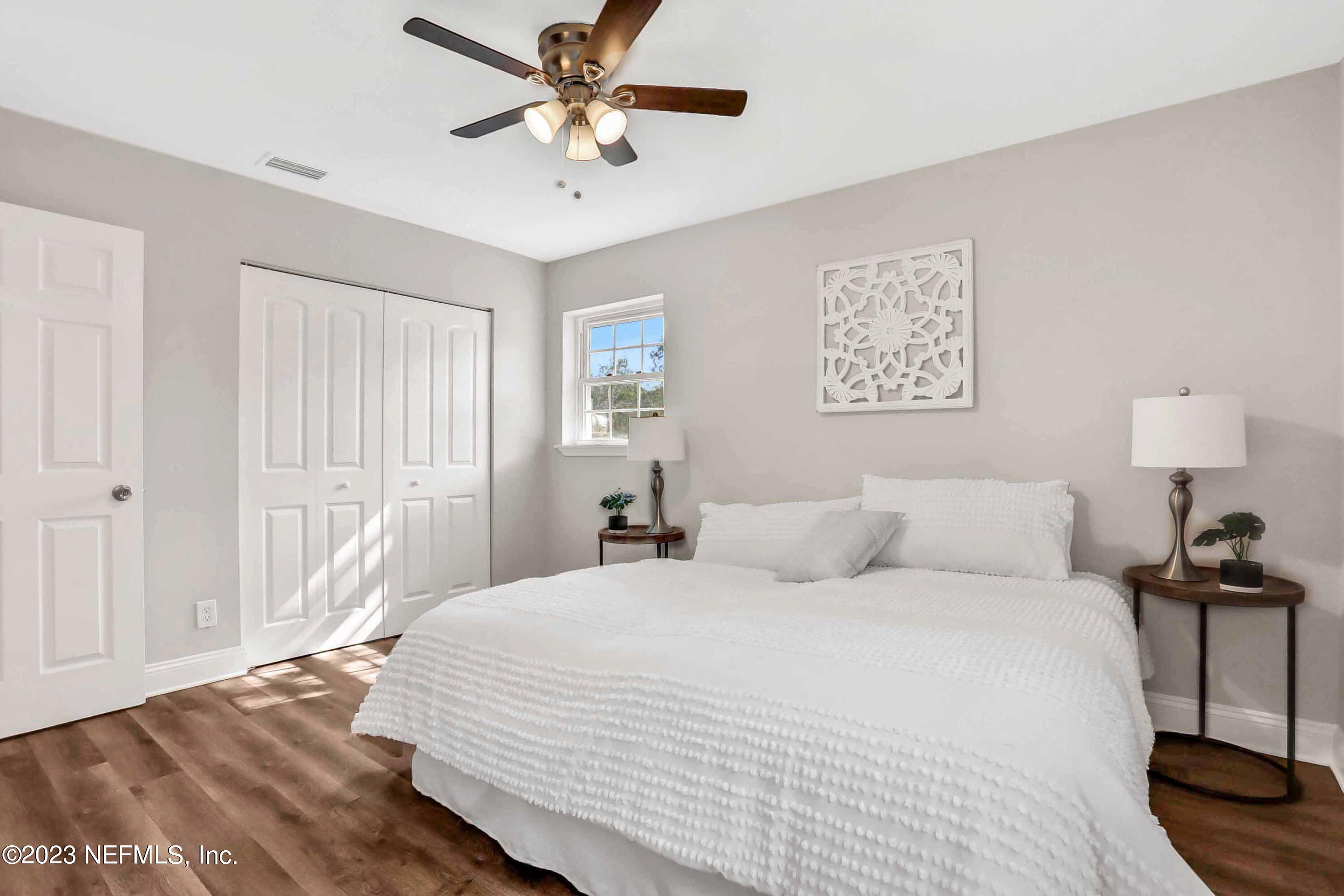 5922 Ridgeway Road East Jacksonville, FL 32244 - Photo 16 of 35 a bedroom with a bed and a lamp on the dresser