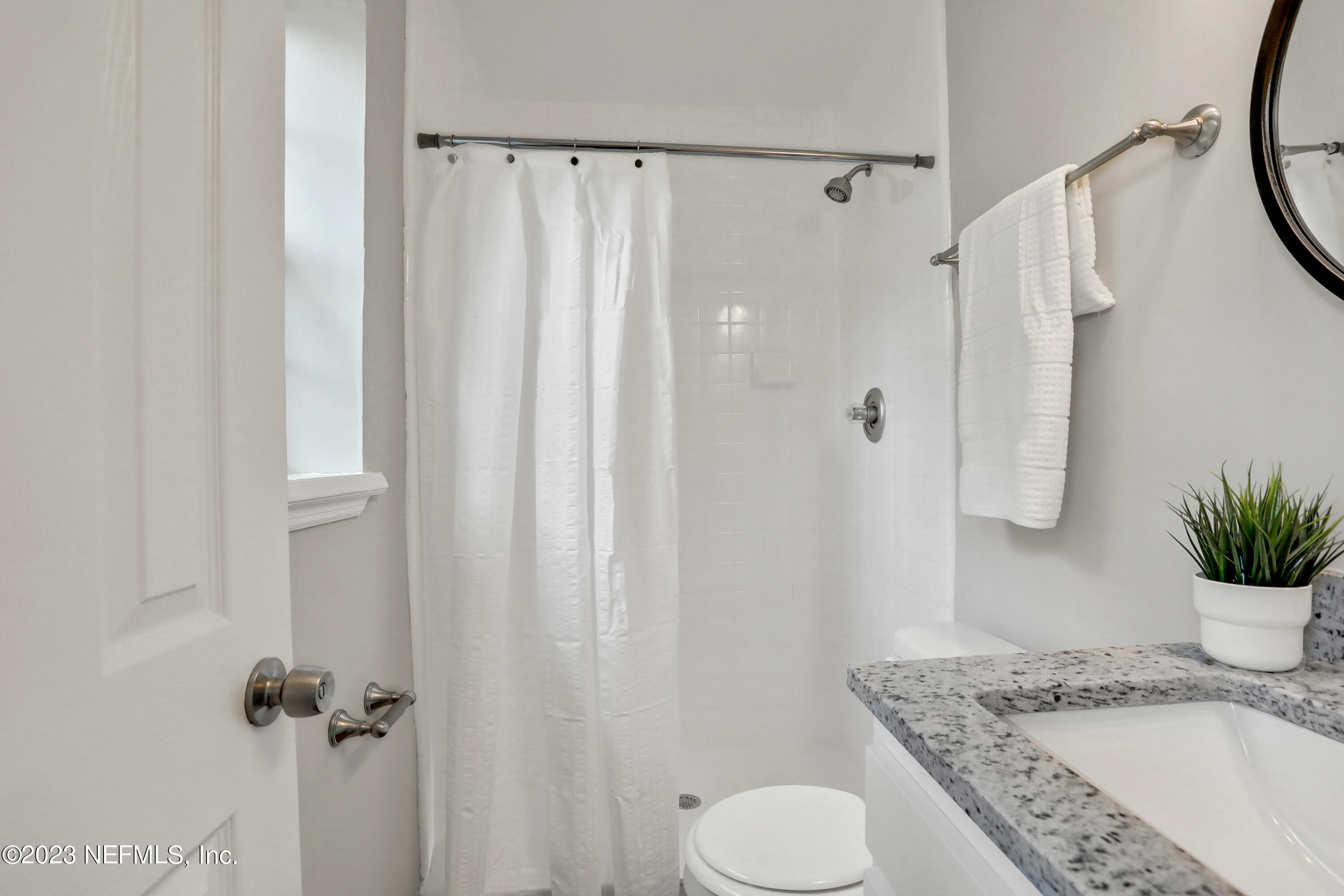 5922 Ridgeway Road East Jacksonville, FL 32244 - Photo 19 of 35 a bathroom with a granite countertop sink toilet and shower