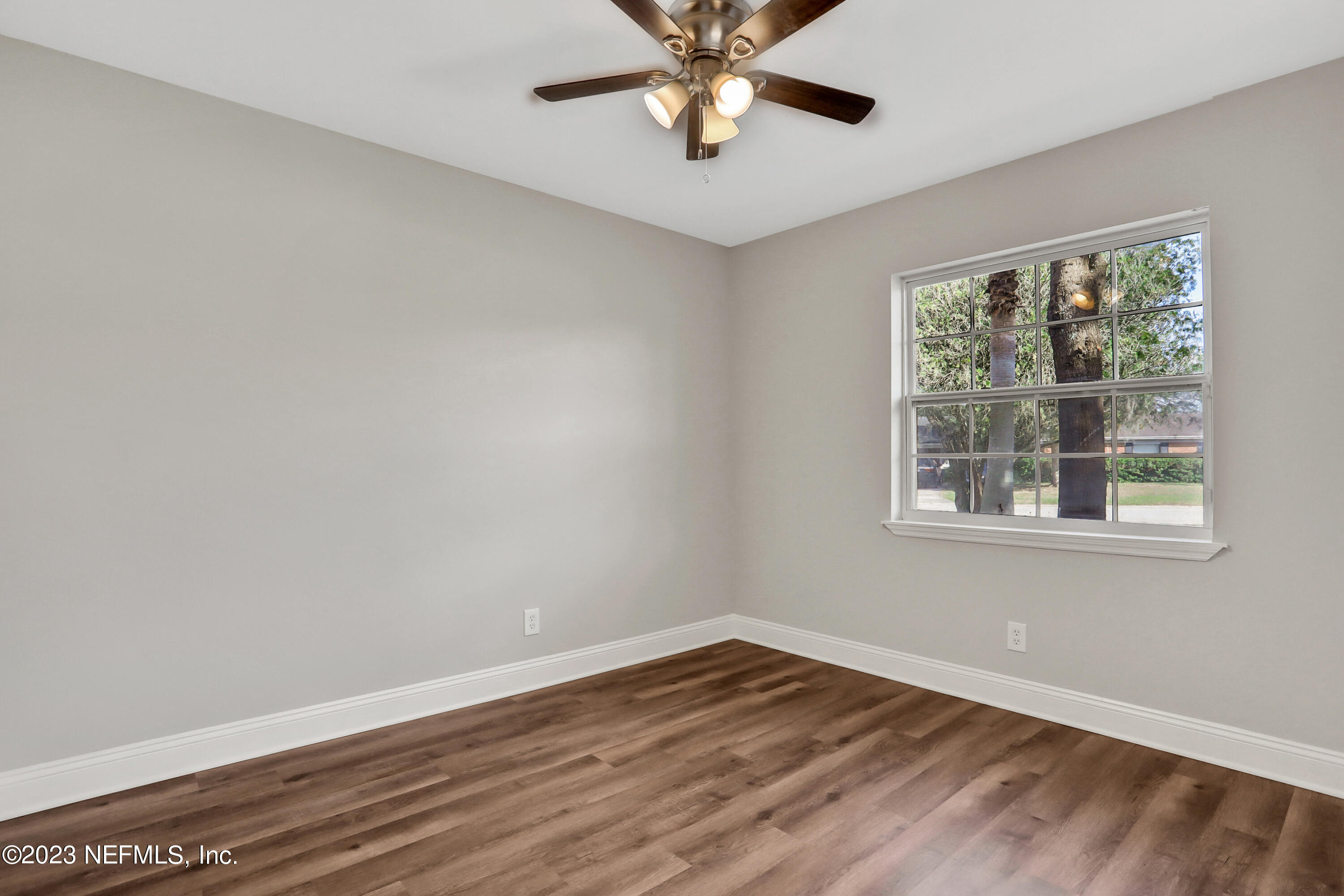 5922 Ridgeway Road East Jacksonville, FL 32244 - Photo 22 of 35 a view of an empty room with wooden floor and a window