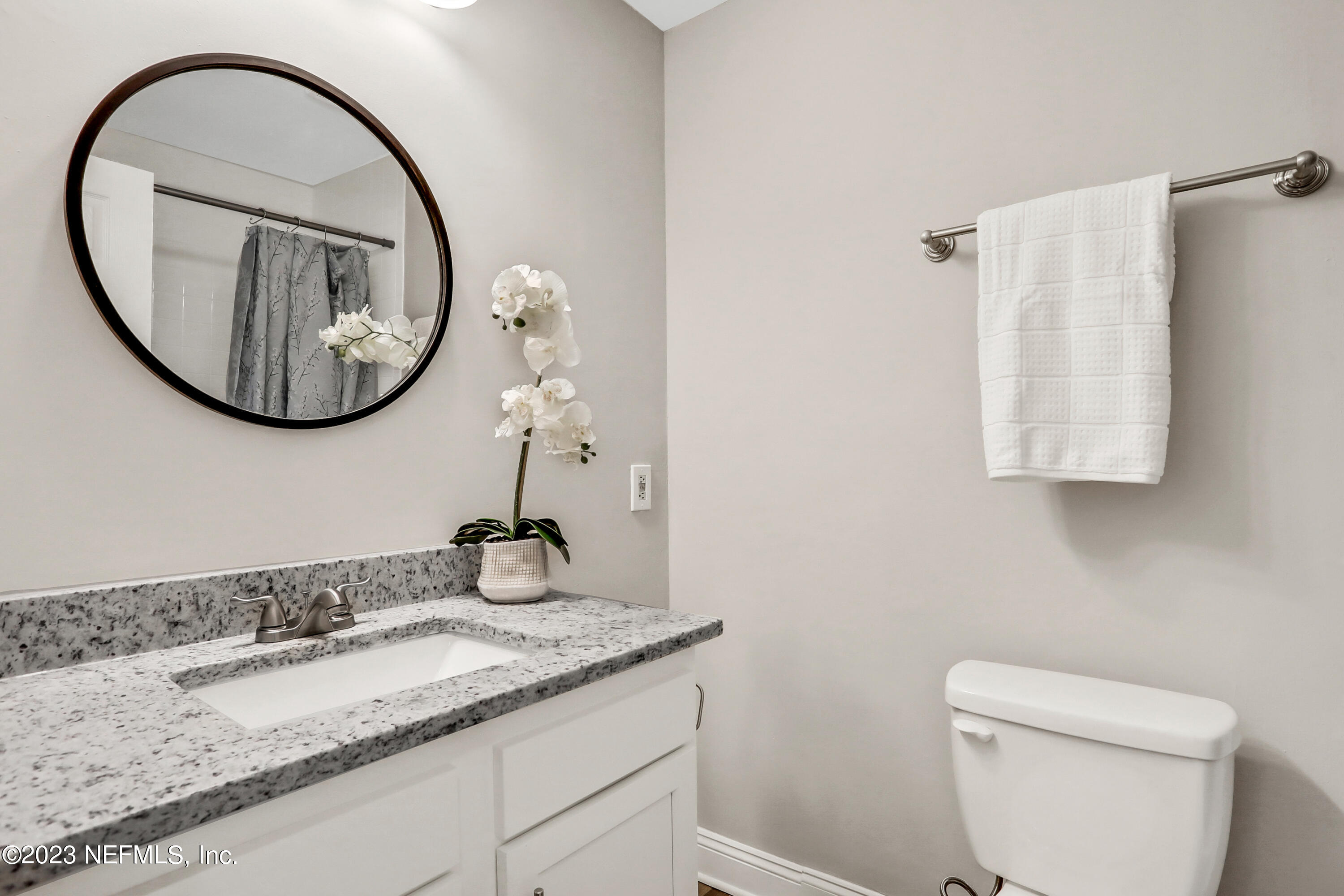 5922 Ridgeway Road East Jacksonville, FL 32244 - Photo 24 of 35 a bathroom with a granite countertop sink and a mirror