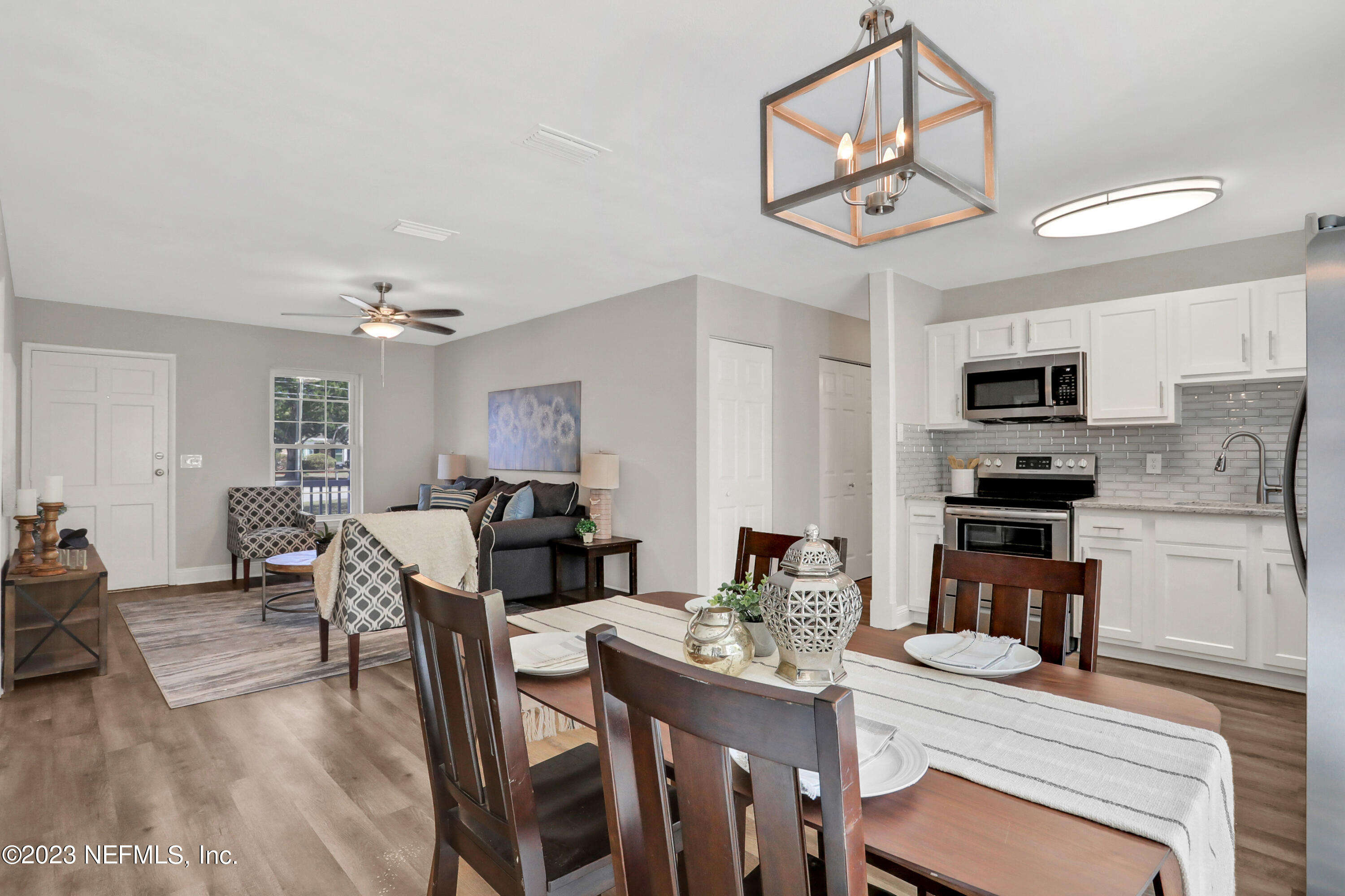 5922 Ridgeway Road East Jacksonville, FL 32244 - Photo 6 of 35 a view of a dining room with furniture a kitchen and chandelier