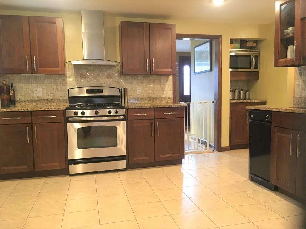 1 Edgar Road Billerica, MA 01821 - Photo 11 of 32 a kitchen with stainless steel appliances granite countertop a stove a refrigerator and a cabinets