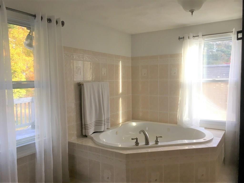 1 Edgar Road Billerica, MA 01821 - Photo 21 of 32 a bath tub sitting in a bathroom next to a window