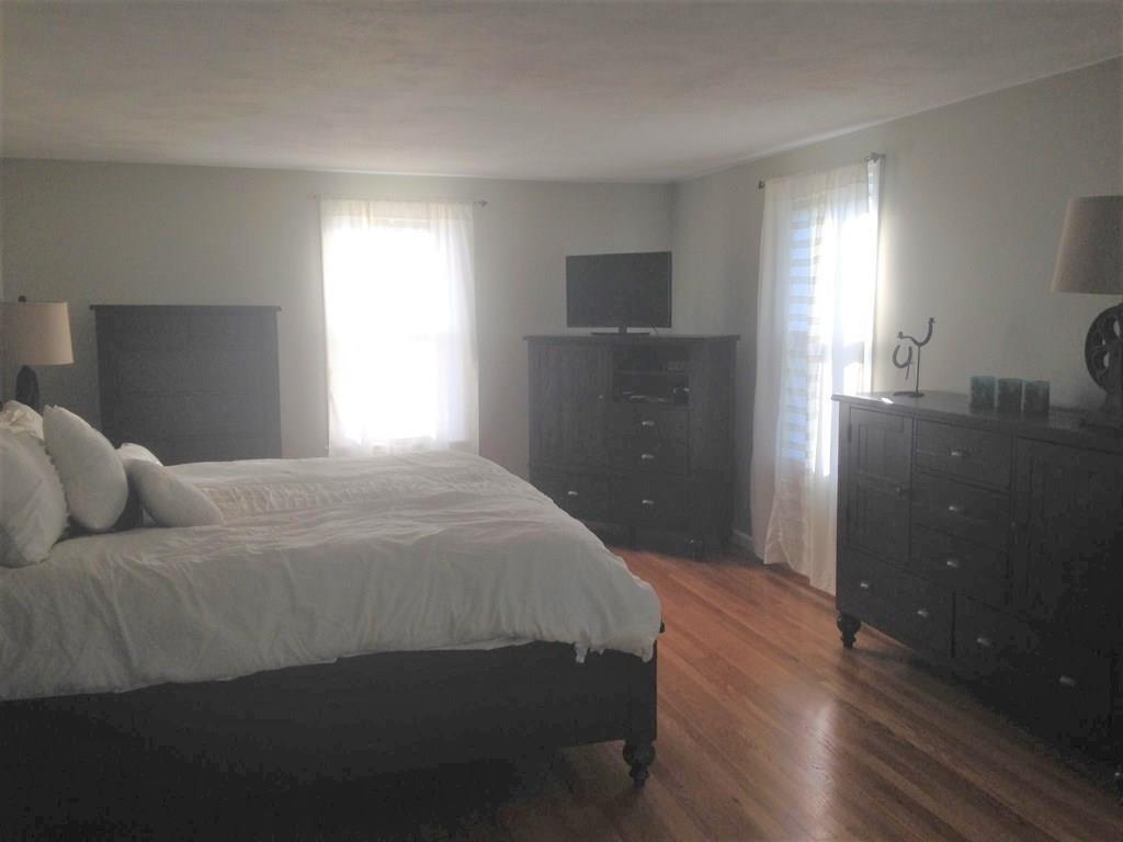 1 Edgar Road Billerica, MA 01821 - Photo 23 of 32 a bedroom with a bed and a lamp on desk