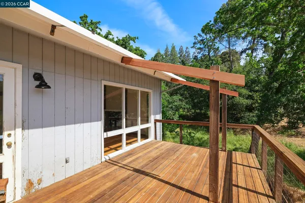 a view of a deck with wooden floor and wooden fence