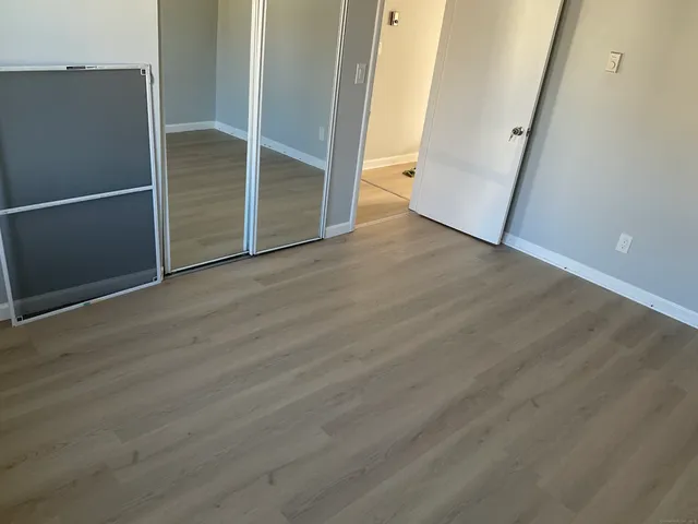 a view of a room with wooden floor and fence