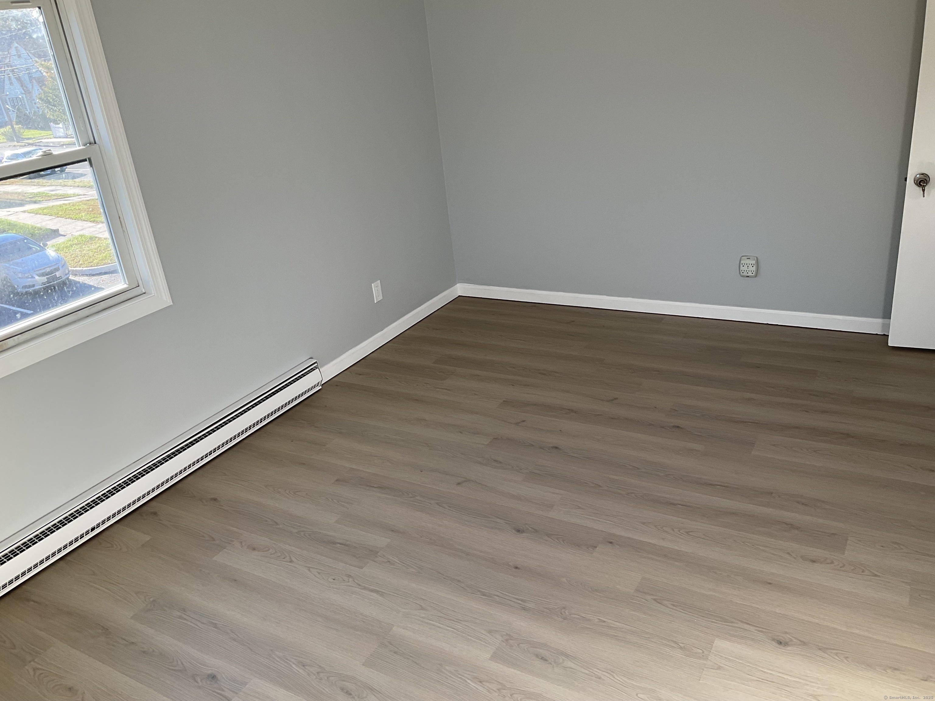 641 Middletown Avenue, Unit 2 New Haven, CT 06513 - Photo 13 of 20 a view of a room with wooden floor and fence