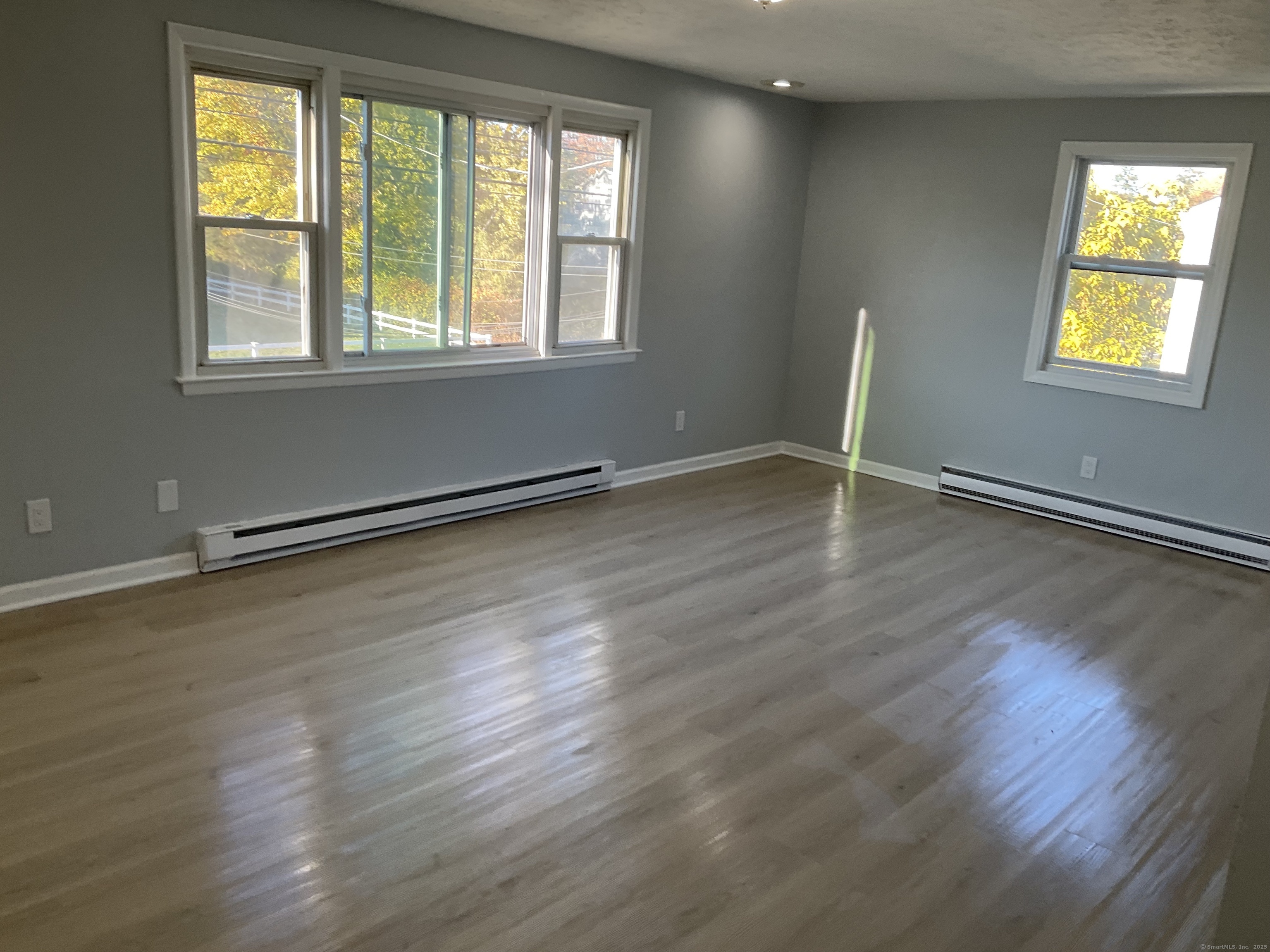 641 Middletown Avenue, Unit 2 New Haven, CT 06513 - Photo 14 of 20 a view of an empty room with wooden floor and a window