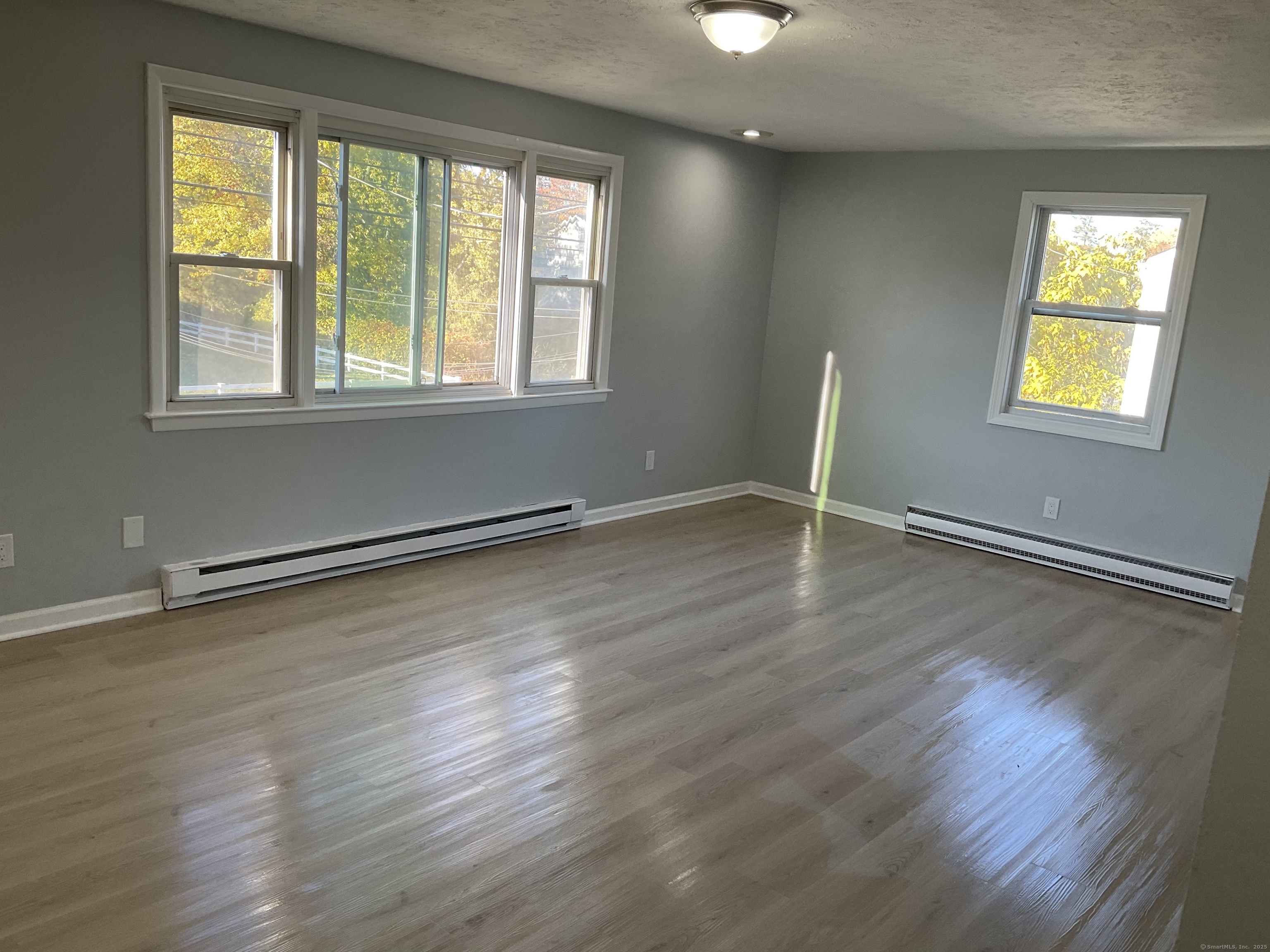 641 Middletown Avenue, Unit 2 New Haven, CT 06513 - Photo 16 of 20 a view of an empty room with wooden floor and a window
