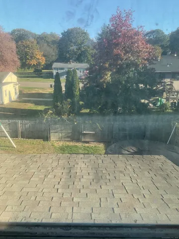 a view of house with deck and outdoor seating