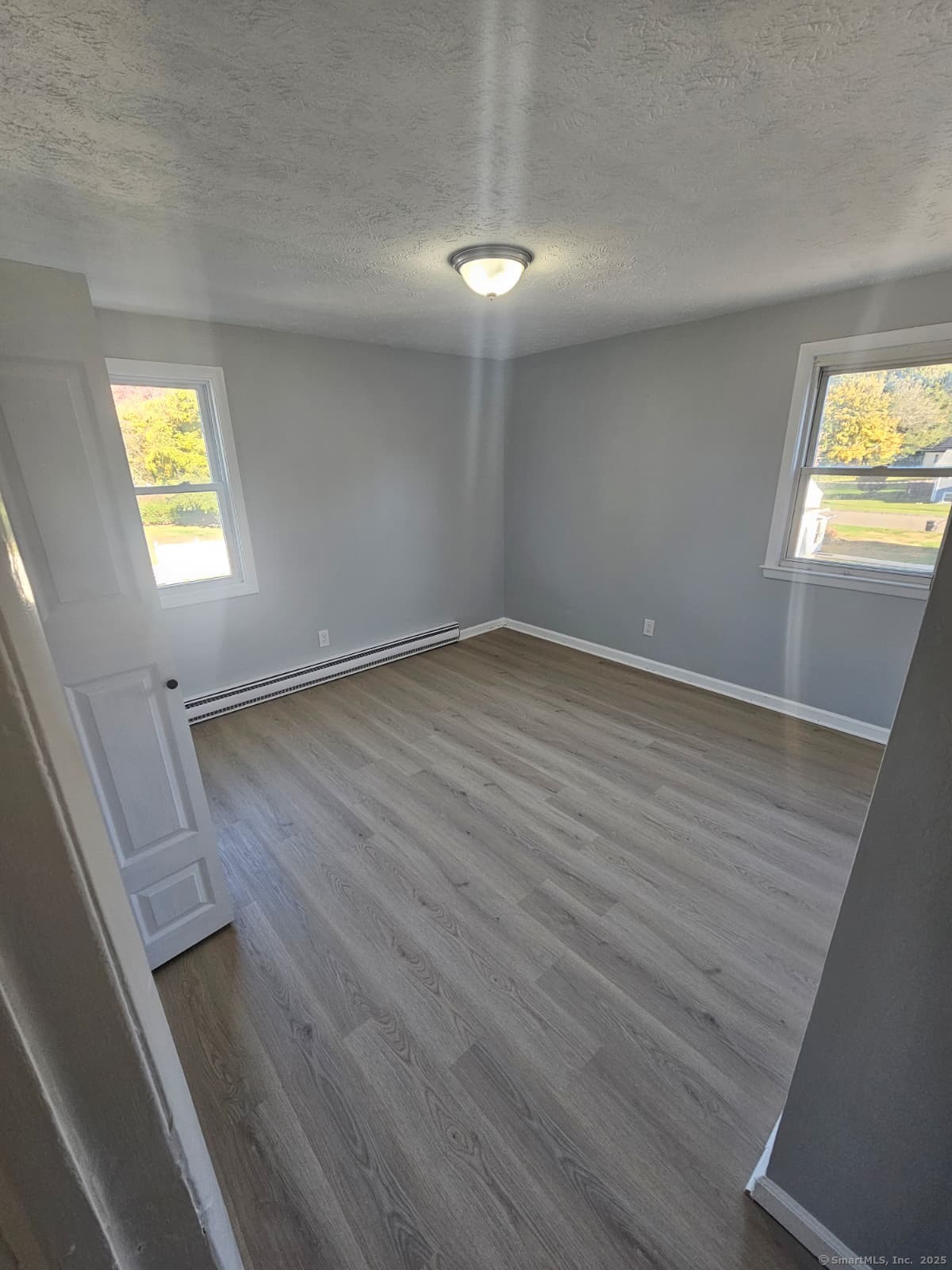 641 Middletown Avenue, Unit 2 New Haven, CT 06513 - Photo 9 of 20 wooden floor in an empty room with a window