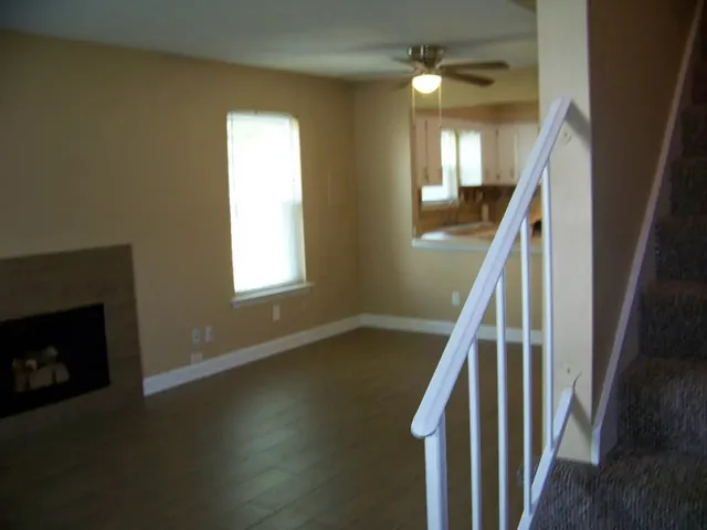 a view of staircase with fireplace and wooden floor