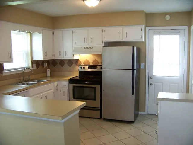 a white refrigerator freezer sitting in a kitchen