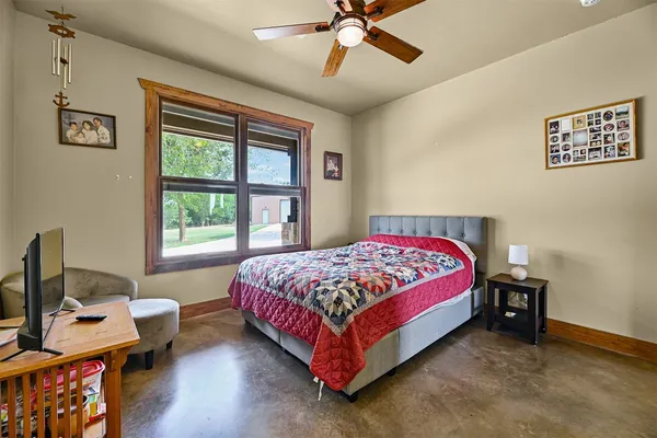 a bathroom with a granite countertop sink toilet and a mirror