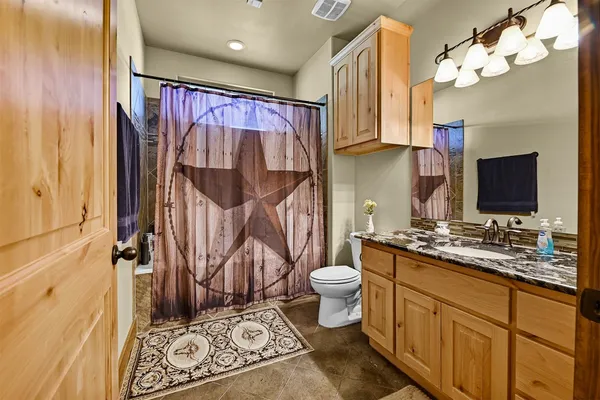 a bedroom with furniture and a large window