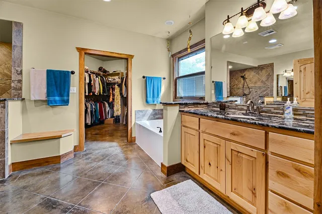 a bathroom with a sink mirror and a shower