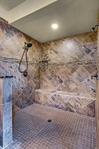 a view of walk in closet with clothes