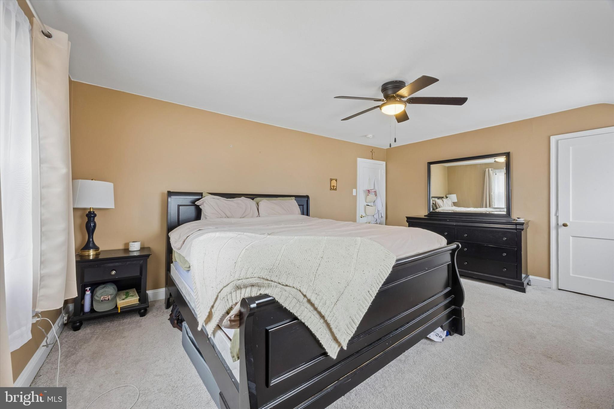 354 East Springfield Road Springfield, PA 19064 - Photo 15 of 22 a spacious bedroom with a bed and a chandelier