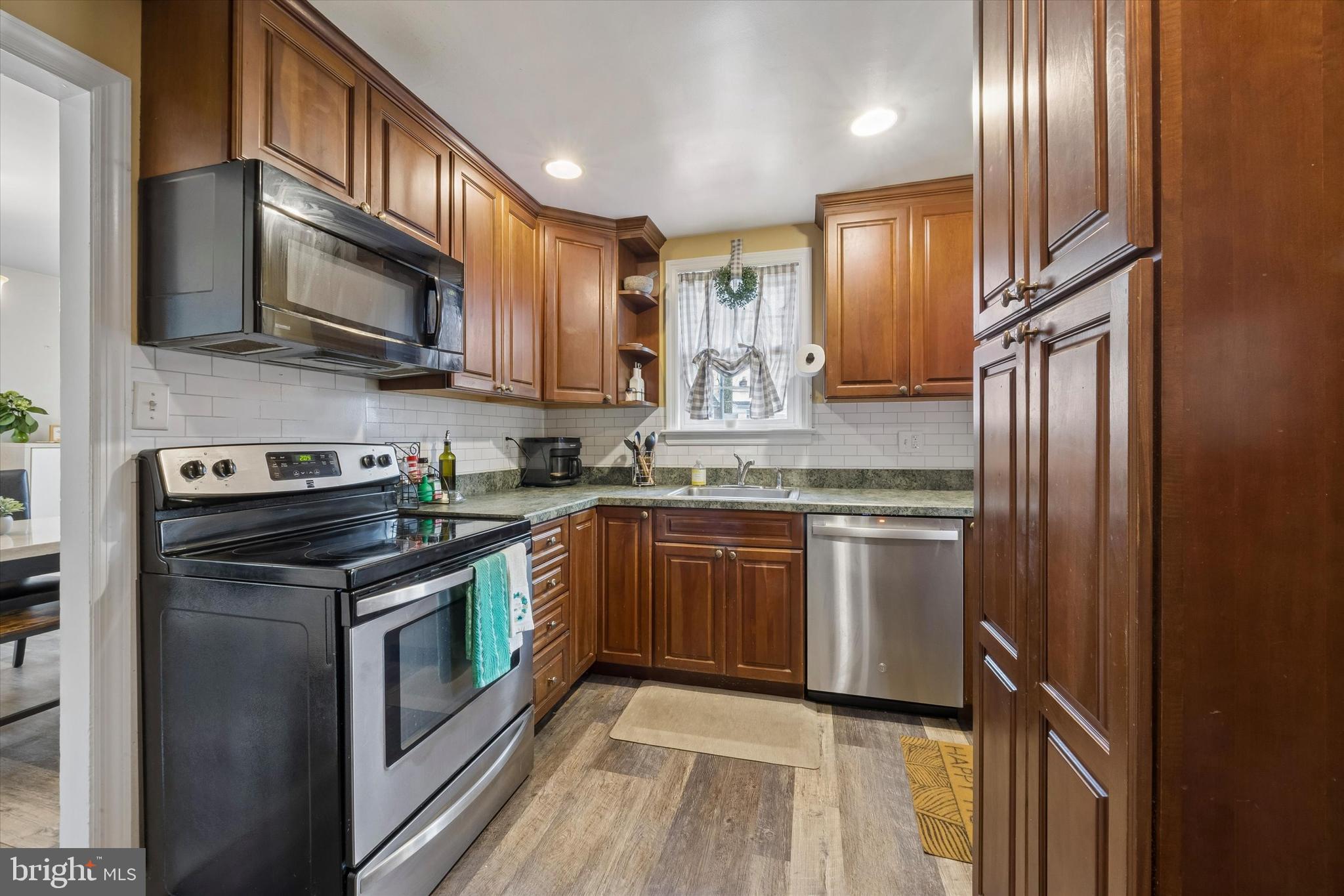 354 East Springfield Road Springfield, PA 19064 - Photo 7 of 22 a kitchen with stainless steel appliances granite countertop a refrigerator a stove top oven a sink and dishwasher