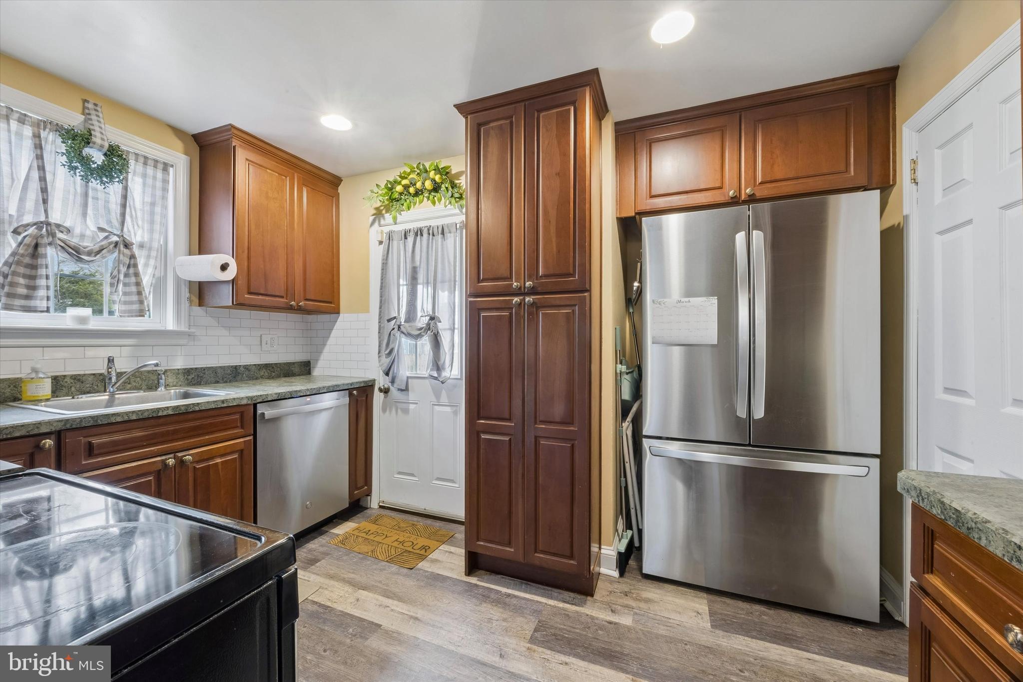354 East Springfield Road Springfield, PA 19064 - Photo 8 of 22 a kitchen with granite countertop stainless steel appliances a refrigerator stove top oven and cabinets