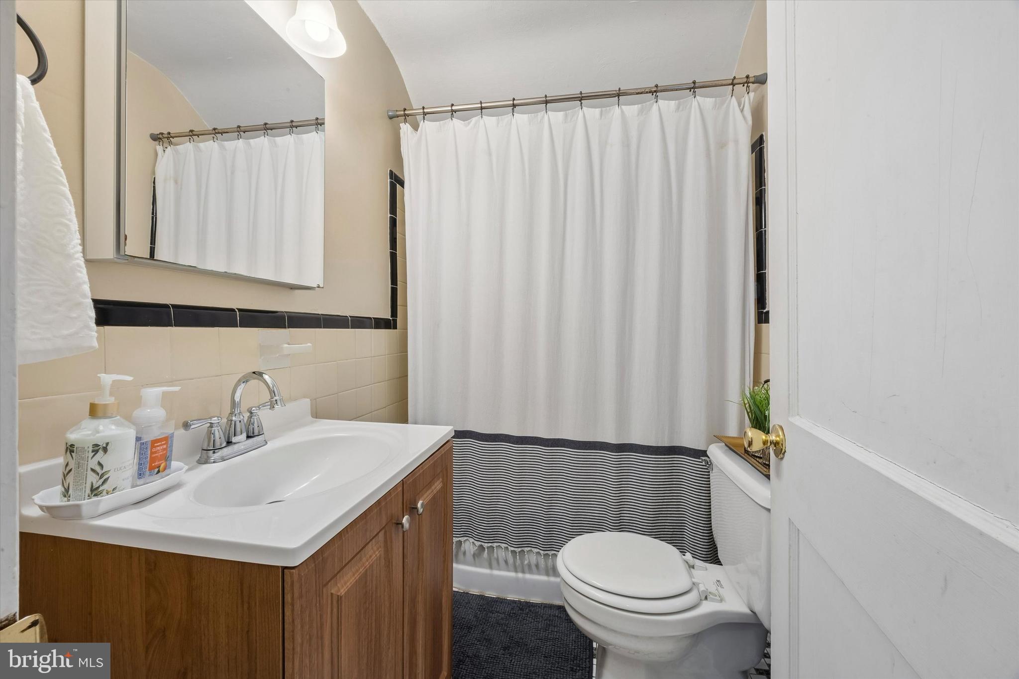 354 East Springfield Road Springfield, PA 19064 - Photo 9 of 22 a bathroom with a sink a toilet and shower curtain