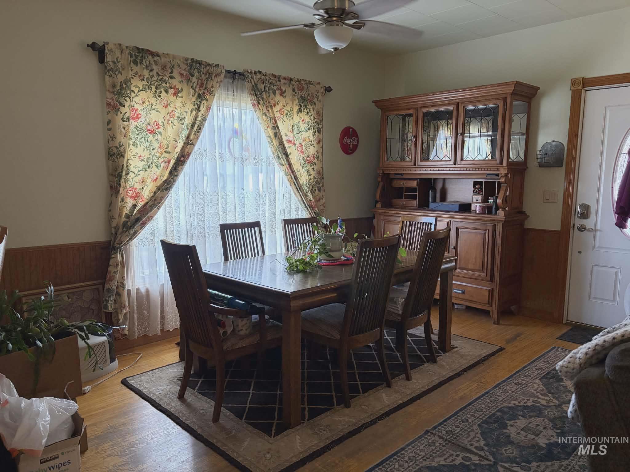 804 Maple Street Kamiah, ID 83536 - Photo 27 of 50 Dining room featuring wainscoting, wood walls, light wood-style flooring, and ceiling fan