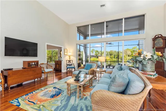 a spacious bedroom with a bed a couch and a chandelier