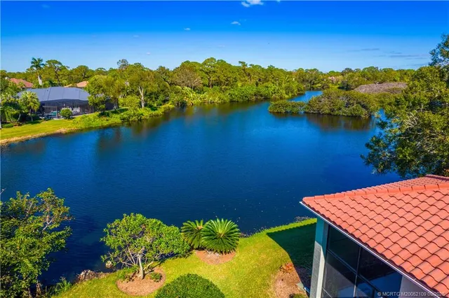 an aerial view of a residential houses with outdoor space and swimming pool