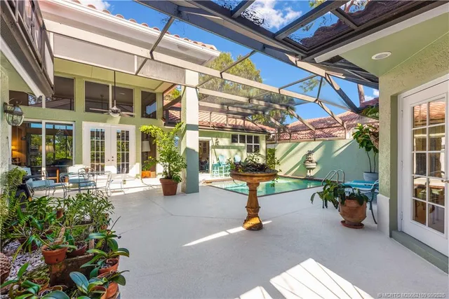 a front view of a house with a garden and patio
