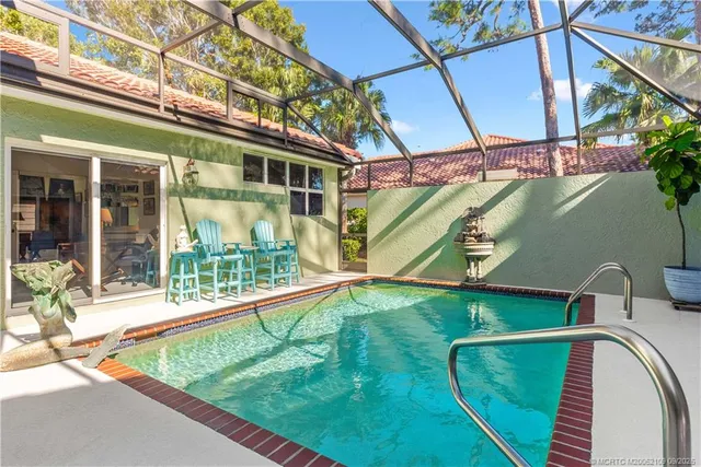 a view of a patio with table and chairs under an umbrella