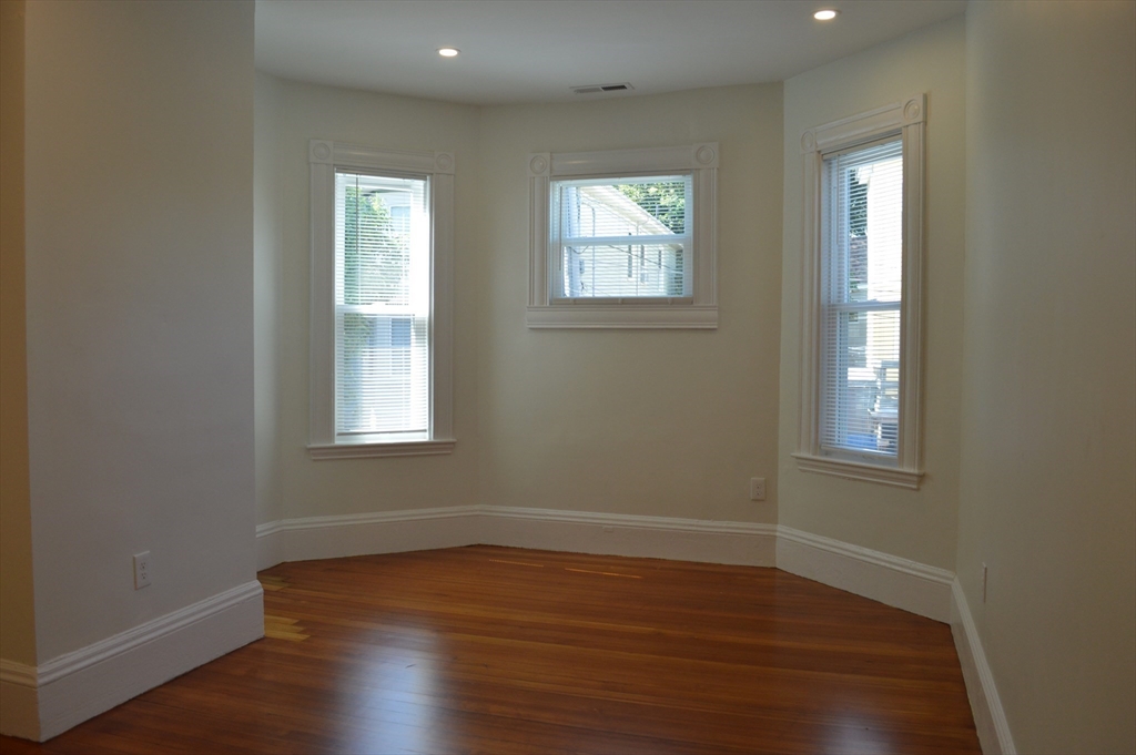 370 A Centre Street, Unit 2 Boston, MA 02130 - Photo 7 of 10 an empty room with wooden floor and windows
