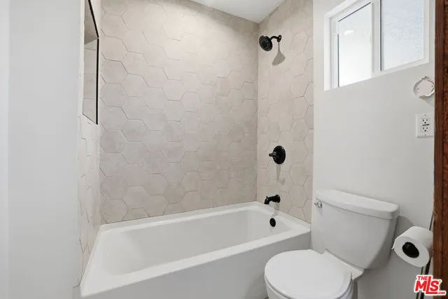 a stove top oven sitting inside of a kitchen