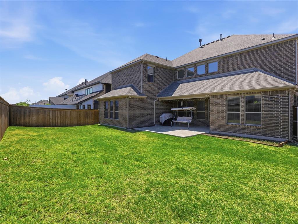 16458 Ryder Rock Road Frisco, TX 75033 - Photo 23 of 24 a view of a house with backyard and a garden