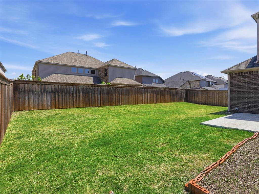 16458 Ryder Rock Road Frisco, TX 75033 - Photo 24 of 24 a front view of a house with garden