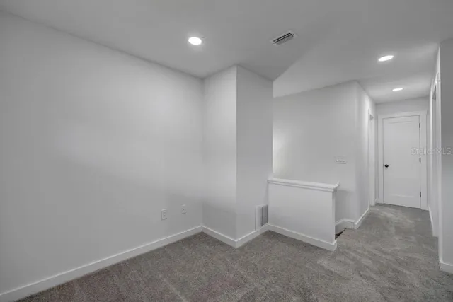 an empty room with closet and ceiling fan