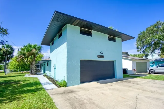 a front view of a house with a garden