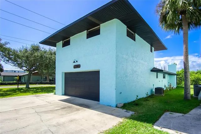 an aerial view of residential house with outdoor space and trees all around