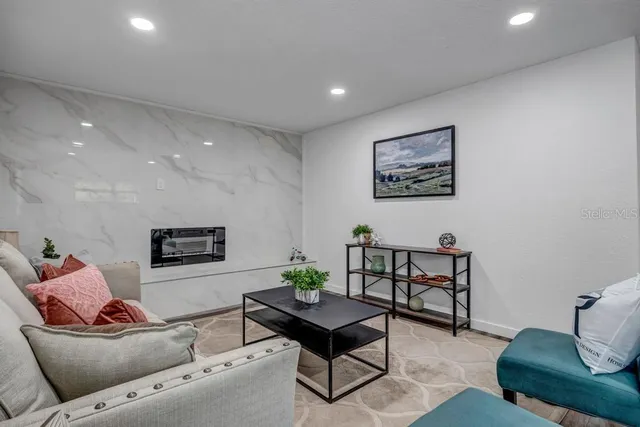 a living room with furniture and a potted plant